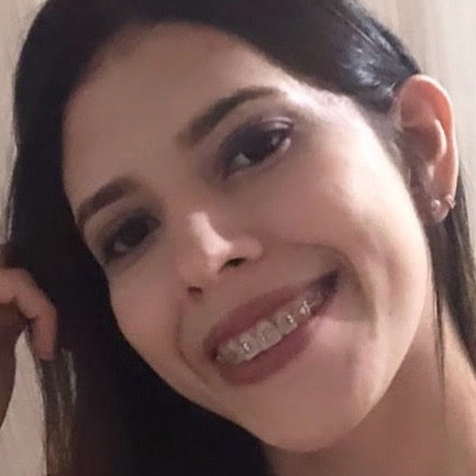 Mulher parda sorridente de cabelos longos e lisos, utilizando aparelho nos dentes.